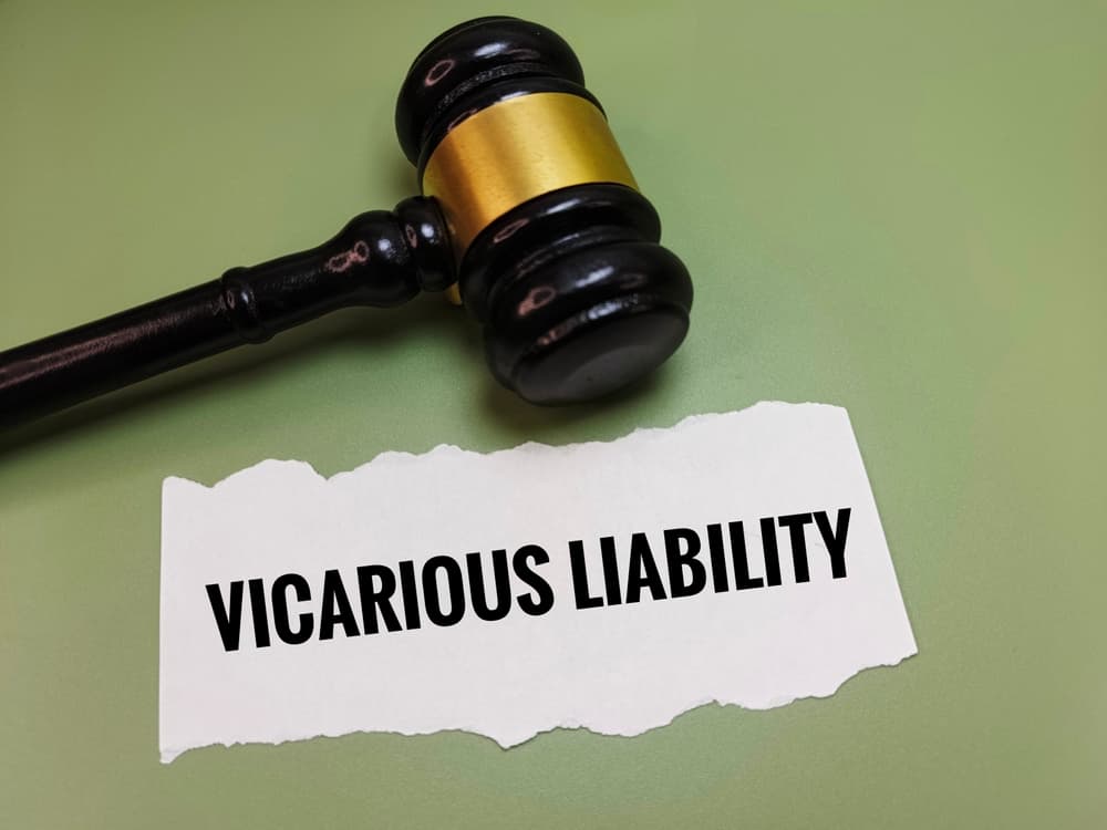 Gavel and torn paper with text Vicarious Liability representing legal concept of employer responsibility in trucking accident cases.