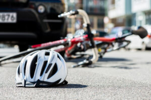 Get help from a bicycle accident lawyer Bicycle and helmet on the ground after a collision in Bellevue, representing the aftermath of a bicycle accident.