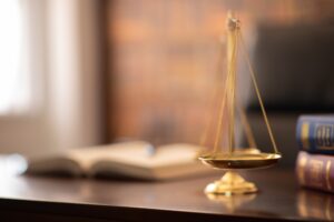 Scales of justice and open law book on a lawyer’s desk, representing premises liability law in Bellevue.