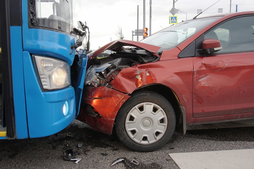Front-end damage after a head-on collision between a car and a bus in Federal Way, showing severe impact at the crash scene.