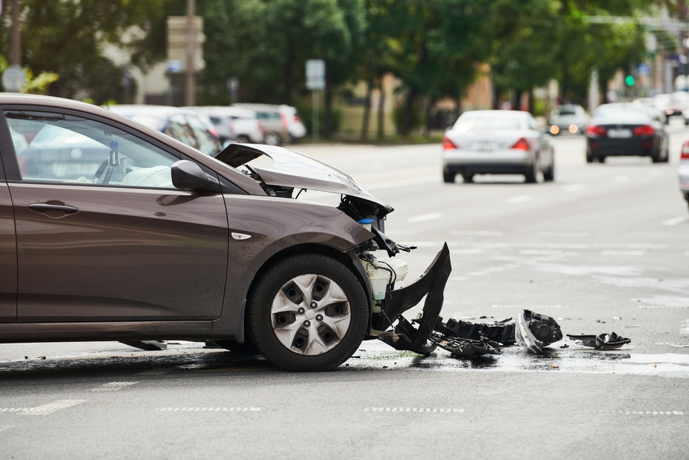 Front-end damage to a car after a hit and run accident in an intersection