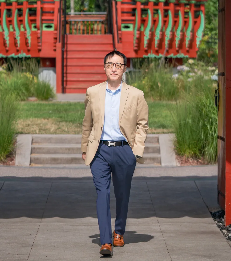 Attorney Chong Ye, personal injury attorney, walking through a Korean pavilion gate